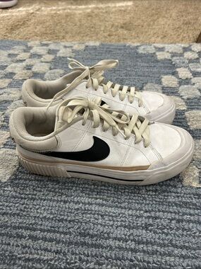 Nike White Low-Top Sneakers with Black Swoosh and Tan Accent
